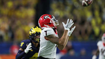 Auburn footballDec 31, 2021; Miami Gardens, Florida, USA; Georgia Bulldogs wide receiver Jermaine Burton (7) catches a pass for a touchdown ahead of Michigan Wolverines defensive back Vincent Gray (4) in the second quarter during the Orange Bowl college football CFP national semifinal game at Hard Rock Stadium. Mandatory Credit: Sam Navarro-USA TODAY Sports