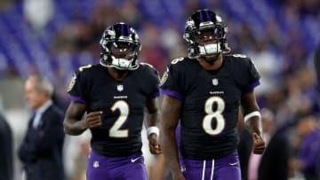 BALTIMORE, MARYLAND - OCTOBER 11: Lamar Jackson #8 and Tyler Huntley #2 of the Baltimore Ravens warm up before a game against the Indianapolis Colts at M&T Bank Stadium on October 11, 2021 in Baltimore, Maryland. (Photo by Patrick Smith/Getty Images)