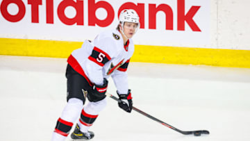 Mar 7, 2021; Calgary, Alberta, CAN; Ottawa Senators defenseman Mike Reilly (5) controls the puck against the Calgary Flames during the second period at Scotiabank Saddledome. Mandatory Credit: Sergei Belski-USA TODAY Sports