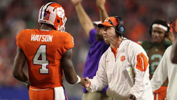 GLENDALE, AZ - DECEMBER 31: Head coach Dabo Swinney (R) of the Clemson Tigers congraulates quarterback Deshaun Watson