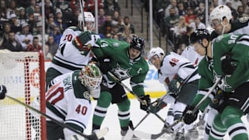Dec 21, 2015; Saint Paul, MN, USA; Minnesota Wild goalie Devan Dubnyk (40) makes a save as Dallas Stars forward Jason Spezza (90) looks for the rebound during the first period at Xcel Energy Center. The Stars won 6-3. Mandatory Credit: Marilyn Indahl-USA TODAY Sports