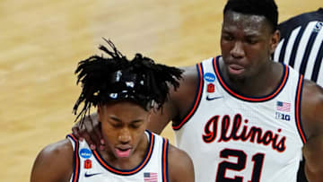 Mar 21, 2021; Indianapolis, Indiana, USA; Illinois Fighting Illini center Kofi Cockburn (21) puts his hand on the shoulder of guard Ayo Dosunmu (11) after a play against the Loyola Ramblers during the second half in the second round of the 2021 NCAA Tournament at Bankers Life Fieldhouse. The Loyola Ramblers won 71-58. Mandatory Credit: Kirby Lee-USA TODAY Sports