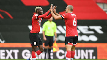 SOUTHAMPTON, ENGLAND - OCTOBER 04: Moussa Djenepo of Southampton celebrates with teammate Oriol Romeu after scoring his sides first goal during the Premier League match between Southampton and West Bromwich Albion at St Mary's Stadium on October 04, 2020 in Southampton, England. Sporting stadiums around the UK remain under strict restrictions due to the Coronavirus Pandemic as Government social distancing laws prohibit fans inside venues resulting in games being played behind closed doors. (Photo by Mike Hewitt/Getty Images)
