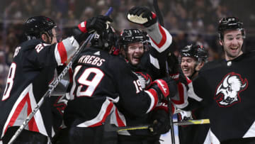 BUFFALO, NEW YORK - JANUARY 07: Victor Olofsson #71 of the Buffalo Sabres celebrates with teammates after scoring the game-winning goal in overtime against the Minnesota Wild at KeyBank Center on January 07, 2023 in Buffalo, New York. (Photo by Joshua Bessex/Getty Images)