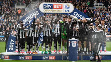 NEWCASTLE UPON TYNE, ENGLAND - MAY 07: Jamaal Lascelles of Newcastle United (L) and Jonjo Shelvey of Newcastle United (R) celebrate with the Championship Trophy after the Sky Bet Championship match between Newcastle United and Barnsley at St James' Park on May 7, 2017 in Newcastle upon Tyne, England. Newcastle United are crowned champions after a 3-0 victory. (Photo by Stu Forster/Getty Images)