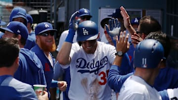 LOS ANGELES, CALIFORNIA - APRIL 14: Cody Bellinger #35 of the Los Angeles Dodgers celebrates in the dugout after scoring off a two RBI single by Alex Verdugo #27 against the Milwaukee Brewers during the first inning at Dodger Stadium on April 14, 2019 in Los Angeles, California. (Photo by Yong Teck Lim/Getty Images)