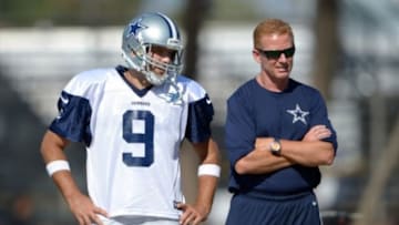 Jul 31, 2014; Oxnard, CA, USA; Dallas Cowboys receiver Tony Romo (9) and coach Jason Garrett at training camp at the River Ridge Fields. Mandatory Credit: Kirby Lee-USA TODAY Sports