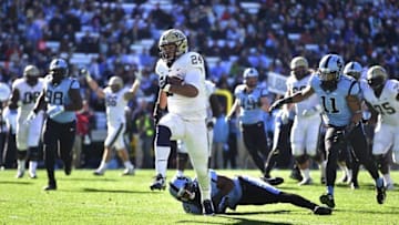 Nov 15, 2014; Chapel Hill, NC, USA; Pittsburgh Panthers running back James Conner (24) runs for a touchdown as North Carolina Tar Heels defensive tackle Justin Thomason (98) and cornerback Desmond Lawrence (2) and running back Malik Simmons (11) defend in the first quarter at Kenan Memorial Stadium. Mandatory Credit: Bob Donnan-USA TODAY Sports