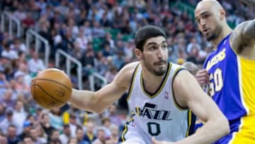 Apr 14, 2014; Salt Lake City, UT, USA; Utah Jazz center Enes Kanter (0) dribbles around Los Angeles Lakers center Robert Sacre (50) during the second half at EnergySolutions Arena. The Lakers won 119-104. Mandatory Credit: Russ Isabella-USA TODAY Sports