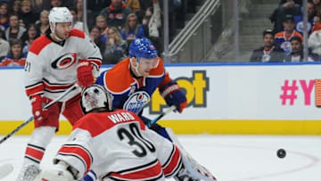 Oct 18, 2016; Edmonton, Alberta, CAN; Edmonton Oilers center Mark Letestu (55) tries to get the puck past Carolina Hurricanes goalie Cam Ward (30) as Canes right winger Lee Stempniak (21) looks on during the second period at Rogers Place. Mandatory Credit: Walter Tychnowicz-USA TODAY Sports