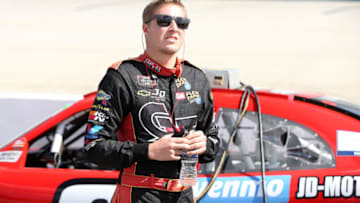 DOVER, DELAWARE - OCTOBER 05: Garrett Smithley, driver of the #0 teamjdmotorsports.com Chevrolet, stands by his car during qualifying for the NASCAR Xfinity Series Use Your Melon Drive Sober 200 at Dover International Speedway on October 05, 2019 in Dover, Delaware. (Photo by Matt Sullivan/Getty Images)