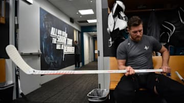 SAN JOSE, CA - DECEMBER 13: Joe Pavelski #8 of the San Jose Sharks adjusts his stick in the locker room before the game against the Dallas Stars at SAP Center on December 13, 2018 in San Jose, California (Photo by Brandon Magnus/NHLI via Getty Images)