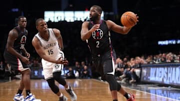 Nov 29, 2016; Brooklyn, NY, USA; Los Angeles Clippers point guard Raymond Felton (2) drives against Brooklyn Nets point guard Isaiah Whitehead (15) in front of Los Angeles Clippers power forward Brandon Bass (30) during the second quarter at Barclays Center. Mandatory Credit: Brad Penner-USA TODAY Sports