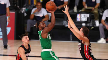 Sep 19, 2020; Lake Buena Vista, Florida, USA; Boston Celtics guard Kemba Walker (8) makes a jump shot over Miami Heat guard Tyler Herro (14) and guard Duncan Robinson (55) during the second half of game three of the Eastern Conference Finals of the 2020 NBA Playoffs at ESPN Wide World of Sports Complex. Mandatory Credit: Kim Klement-USA TODAY Sports