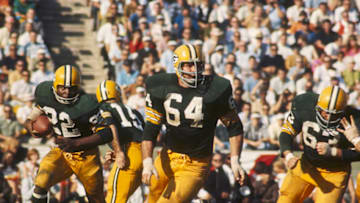 Green Bay Packers guard Jerry Kramer (64) leads the blocking for running back Elijah Pitts (22) during Super Bowl I, a 35-10 victory over the Kansas City Chiefs on January 15, 1967, at the Los Angeles Memorial Coliseum in Los Angeles, California. (Photo by James Flores/Getty Images) *** Local Caption ***