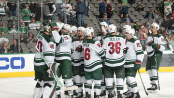 DALLAS, TX - OCTOBER 19: Devan Dubnyk #40 of the Minnesota Wild is congratulated by his teammates on a win against the Dallas Stars at the American Airlines Center on October 19, 2018 in Dallas, Texas. (Photo by Glenn James/NHLI via Getty Images)