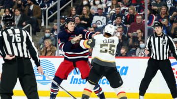 Mar 15, 2022; Winnipeg, Manitoba, CAN; Winnipeg Jets defenseman Logan Stanley (64) fights Vegas Golden Knights forward Keegan Kolesar (55) during the first period at Canada Life Centre. Mandatory Credit: Terrence Lee-USA TODAY Sports