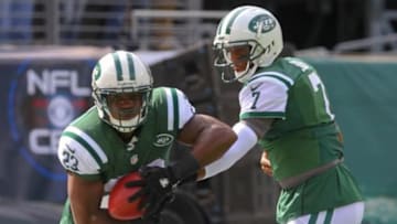Oct 13, 2013; East Rutherford, NJ, USA; New York Jets quarterback Geno Smith (7) hands the ball to New York Jets running back Mike Goodson (23) during the pre game warmups for their game against the Pittsburgh Steelers at MetLife Stadium. Mandatory Credit: Ed Mulholland-USA TODAY Sports
