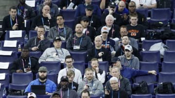 INDIANAPOLIS, IN - MARCH 01: Coaches and scouts from NFL teams time Damien Harris of Alabama as he runs the 40-yard dash during day two of the NFL Combine at Lucas Oil Stadium on March 1, 2019 in Indianapolis, Indiana. (Photo by Joe Robbins/Getty Images)