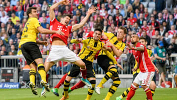 MUNICH, GERMANY - APRIL 08: Robert Lewandowski of Bayern Muenchen in action against Marc Aregall Bartra (M) of Dortmund and Sokratis of Dortmund (L) during the Bundesliga match between Bayern Muenchen and Borussia Dortmund at Allianz Arena on April 8, 2017 in Munich, Germany. (Photo by Alexander Scheuber/Getty Images Fuer MAN)