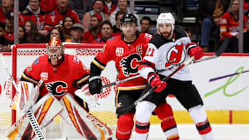 CALGARY, ALBERTA - NOVEMBER 07: Mark Giordano #5 of the Calgary Flames skates against Kyle Palmieri #21 of the New Jersey Devils at Scotiabank Saddledome on November 07, 2019 in Calgary, Canada. (Photo by Gerry Thomas/NHLI via Getty Images)
