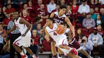 Jan 27, 2016; Fayetteville, AR, USA; Arkansas Razorbacks guard Jabril Durham (4) dribbles past Texas A&M Aggies center Tyler Davis (34) in the first half at Bud Walton Arena. Mandatory Credit: Gunnar Rathbun-USA TODAY Sports