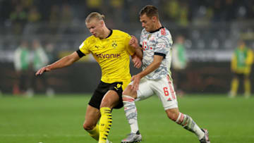 Erling Haaland is challenged by Joshua Kimmich. (Photo by Lars Baron/Getty Images)