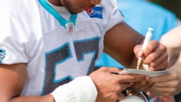 Jun 15, 2016; Charlotte, NC, USA; Carolina Panthers linebacker Jeremy Cash (57) signs an autograph at the practice field at Bank of America Stadium. Mandatory Credit: Jeremy Brevard-USA TODAY Sports