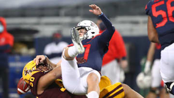 Dec 11, 2020; Tucson, Arizona, USA; Arizona Wildcats quarterback Grant Gunnell (17) fumbles the ball as he is tackled by Arizona State Sun Devils defensive lineman Jermayne Lole (90) during the Territorial Cup at Arizona Stadium. Mandatory Credit: Mark J. Rebilas-USA TODAY Sports