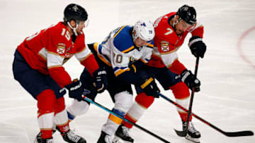 SUNRISE, FL - FEBRUARY 5: Riley Sheahan #15 and Colton Sceviour #7 of the Florida Panthers skates for possession against Oskar Sundqvist #70 of the St. Louis Blues at the BB&T Center on February 5, 2019 in Sunrise, Florida. (Photo by Eliot J. Schechter/NHLI via Getty Images)