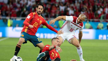 KALININGRAD, RUSSIA - JUNE 25 : Noureddine Ambarat (R) of Morocco in action against Isco (L) and Sergio Ramos (bottom) of Spain during the 2018 FIFA World Cup Russia Group B match between Spain and Morocco at the Kaliningrad Stadium in Kaliningrad, Russia on June 25, 2018. (Photo by Andrey Bogunov/Anadolu Agency/Getty Images)