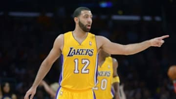 Feb 19, 2014; Los Angeles, CA, USA; Los Angeles Lakers guard Kendall Marshall (12) reacts against the Houston Rockets at Staples Center. The Rockets defeated the Lakers 134-108. Mandatory Credit: Kirby Lee-USA TODAY Sports