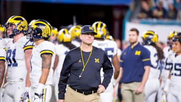 MIAMI GARDENS, FL - DECEMBER 30: Michigan Wolverines Head Coach Jim Harbaugh on the field with his players before the start of the NCAA Capital One Orange Bowl football game between the Michigan Wolverines and the Florida State Seminoles on December 30, 2016, at the Hard Rock Stadium in Miami Gardens, FL (Photo by Doug Murray/Icon Sportswire via Getty Images)