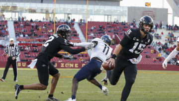 AMES, IA - DECEMBER 5: Quarterback Brock Purdy #15 of the Iowa State Cyclones drive the ball in for a touch down as wide receiver Sean Shaw Jr. #2 of the Iowa State Cyclones blocks cornerback Nicktroy Fortune #11 of the West Virginia Mountaineers in the first half of play at Jack Trice Stadium on December 5, 2020 in Ames, Iowa. The Iowa State Cyclones won 42-6 over the West Virginia Mountaineers. (Photo by David K Purdy/Getty Images)