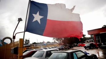 HOUSTON, TX - AUGUST 26: Wind from Hurricane Harvey batters a Texas flag on August 26, 2017 in Houston, Texas. Harvey, which made landfall north of Corpus Christi late last night, is expected to dump upwards to 40 inches of rain in Texas over the next couple of days. (Photo by Scott Olson/Getty Images)