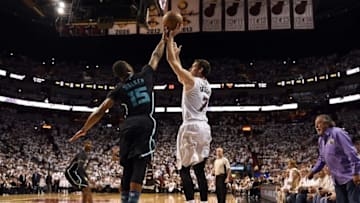 Apr 27, 2016; Miami, FL, USA; Miami Heat guard Goran Dragic (7) shoots over Charlotte Hornets guard Kemba Walker (15) during the second half in game five of the first round of the NBA Playoffs at American Airlines Arena. Mandatory Credit: Steve Mitchell-USA TODAY Sports