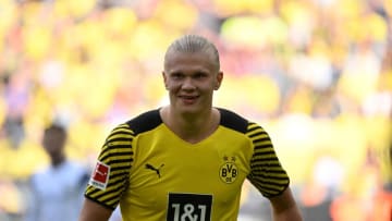 Dortmund's Norwegian forward Erling Braut Haaland (L) celebrates scoring his team's third goal to lead 3:2 during the German first division Bundesliga football match between Borussia Dortmund and VfL Bochum in Dortmund, western Germany on April 30, 2022. - DFL REGULATIONS PROHIBIT ANY USE OF PHOTOGRAPHS AS IMAGE SEQUENCES AND/OR QUASI-VIDEO (Photo by INA FASSBENDER / AFP) / DFL REGULATIONS PROHIBIT ANY USE OF PHOTOGRAPHS AS IMAGE SEQUENCES AND/OR QUASI-VIDEO (Photo by INA FASSBENDER/AFP via Getty Images)