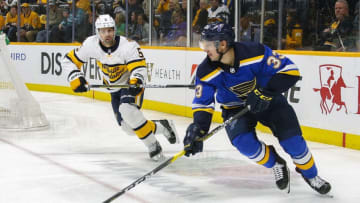 NASHVILLE, TENNESSEE - FEBRUARY 16: Jordan Kyrou #33 of the St. Louis Blues carries the puck past Dan Hamhuis #5 of the Nashville Predators during the second period at Bridgestone Arena on February 16, 2020 in Nashville, Tennessee. (Photo by Frederick Breedon/Getty Images)