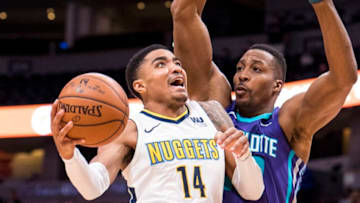 DENVER, CO - FEBRUARY 05: Gary Harris #14 of the Denver Nuggets drives to the basket against Dwight Howard #12 of the Charlotte Hornets at the Pepsi Center on February 5, 2018 in Denver, Colorado. NOTE TO USER: User expressly acknowledges and agrees that, by downloading and or using this photograph, User is consenting to the terms and conditions of the Getty Images License Agreement. (Photo by Timothy Nwachukwu/Getty Images)