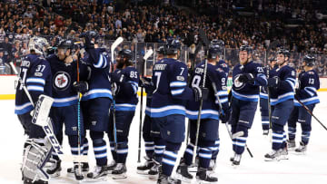 WINNIPEG, MB - DECEMBER 11: Members of the Winnipeg Jets celebrate following a 5-1 victory over the Vancouver Canucks at the Bell MTS Place on December 11, 2017 in Winnipeg, Manitoba, Canada. (Photo by Darcy Finley/NHLI via Getty Images)