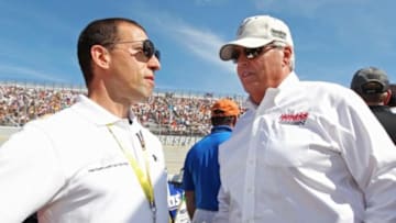 Sep 28, 2014; Dover, DE, USA; NASCAR Sprint Cup Series car owner Rob Kauffman (left) talks to NASCAR Sprint Cup Series car owner Rick Hendrick (right) prior to the AAA 400 at Dover International Speedway. Mandatory Credit: Matthew O