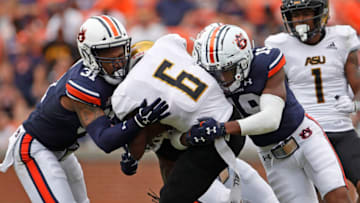 Auburn footballSep 11, 2021; Auburn, Alabama, USA; Auburn Tigers linebacker Chandler Wooten (31) and safety Bydarrius Knighten (19) tackle Alabama State Hornets receiver Keron Jones (6) during the third quarter at Jordan-Hare Stadium. Mandatory Credit: John Reed-USA TODAY Sports