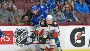 VANCOUVER, BC - MARCH 27: Troy Terry #61 of the Anaheim Ducks checks Sam Gagner #89 of the Vancouver Canucks during their NHL game at Rogers Arena March 27, 2018 in Vancouver, British Columbia, Canada. (Photo by Jeff Vinnick/NHLI via Getty Images)