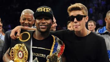 Sep 14, 2013; Las Vegas, NV, USA; Floyd Mayweather Jr (left) and Justin Bieber appear in the ring after Mayweather defeated Canelo Alvarez by a majority decision at their WBC and WBA super welterweight titles fight at MGM Grand Garden Arena. Mandatory Credit: Jayne Kamin-Oncea-USA TODAY Sports