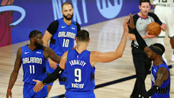 LAKE BUENA VISTA, FLORIDA - AUGUST 18: James Ennis III #11, Nikola Vucevic #9 and Terrence Ross #31 of the Orlando Magic celebrate after beating the Milwaukee Bucks in Game One in the first round of the NBA playoffs at The Field House at ESPN Wide World Of Sports Complex on August 18, 2020 in Lake Buena Vista, Florida. NOTE TO USER: User expressly acknowledges and agrees that, by downloading and/or using this Photograph, user is consenting to the terms and conditions of the Getty Images License Agreement. (Photo by Kim Klement-Pool/Getty Images)