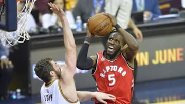 May 19, 2016; Cleveland, OH, USA; Toronto Raptors forward DeMarre Carroll (5) shoots the ball as Cleveland Cavaliers forward Kevin Love (0) defends in the third quarter in game two of the Eastern conference finals of the NBA Playoffs at Quicken Loans Arena. Mandatory Credit: David Richard-USA TODAY Sports