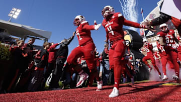 Nov 14, 2015; Louisville, KY, USA; Louisville Cardinals offensive lineman Lukayus McNeil (72) and running back Corvin Lamb (4) lead the team to the field before the first half against the Virginia Cavaliers at Papa John