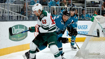 SAN JOSE, CA - APRIL 7: Tyler Ennis #63 of the Minnesota Wild and Kevin Labanc #62 of the San Jose Sharks battle behind the net at SAP Center on April 7, 2018 in San Jose, California. (Photo by Don Smith/NHLI via Getty Images)