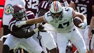 Auburn tight end John Samuel Shenker (47) stiff arms Texas A&M defensive lineman Tyree Johnson (3) at Kyle Field in College Station, Texas, on Saturday, Sept. 21, 2019. Auburn leads Texas A&M 14-3 at halftime.Jc Auburntamu 45