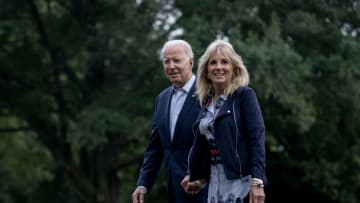 WASHINGTON, DC - JULY 18: U.S. President Joe Biden (L) and first lady Jill Biden walk on the South Lawn of the White House on July 18, 2021 in Washington, DC. The Bidens were returning from a weekend at the presidential retreat at Camp David. (Photo by Stefani Reynolds/Getty Images)